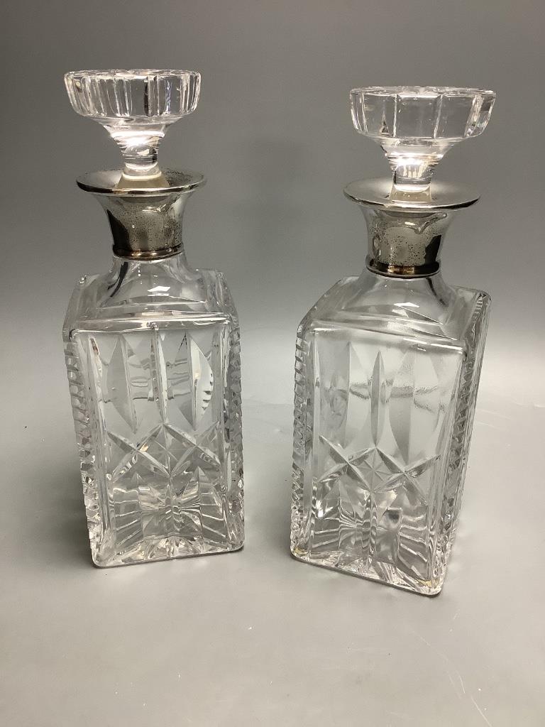 A pair of silver collared cut glass decanters, height 27cm